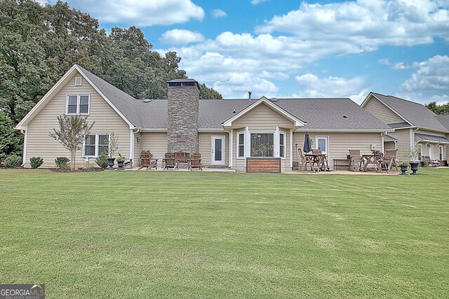 view of front of property with a front lawn and a patio area