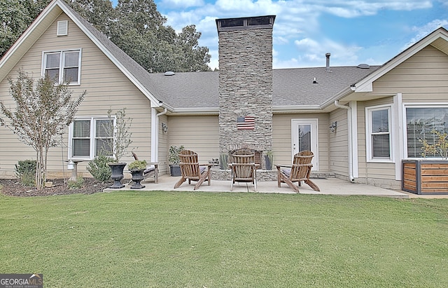 rear view of property with a yard and a patio area