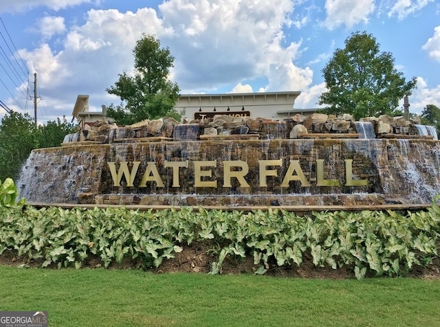 community / neighborhood sign with a lawn