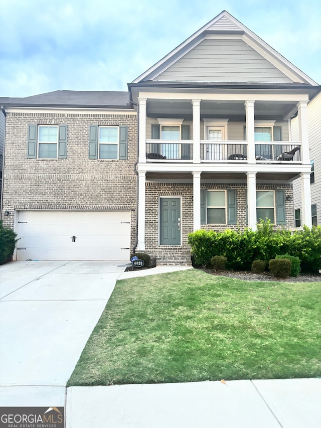 view of front of house with a balcony, a garage, and a front yard