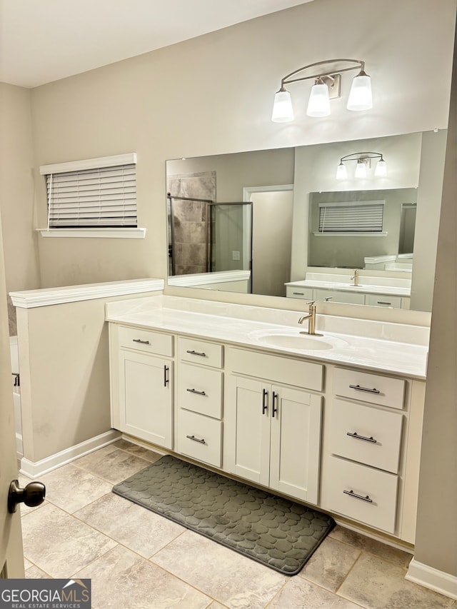 bathroom with a shower with door and vanity