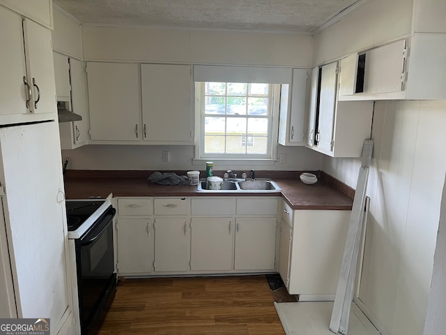 kitchen with a textured ceiling, dark hardwood / wood-style floors, black electric range, sink, and white cabinetry