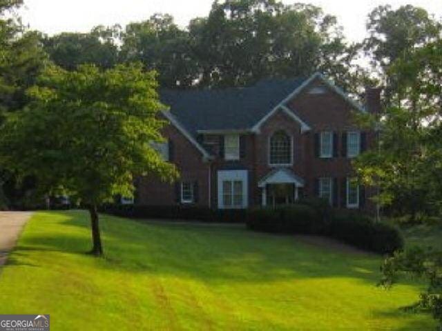 colonial-style house with a front yard