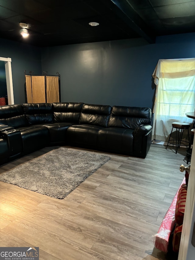 living room with beamed ceiling and hardwood / wood-style floors