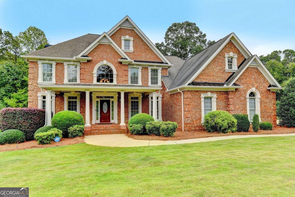 view of front facade with a front yard and a porch