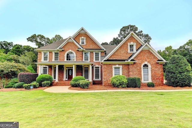 view of front facade with covered porch and a front yard