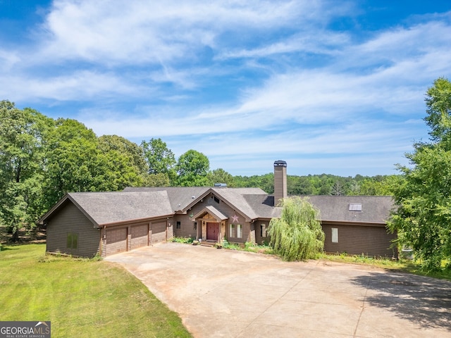 ranch-style house with a front yard and a garage