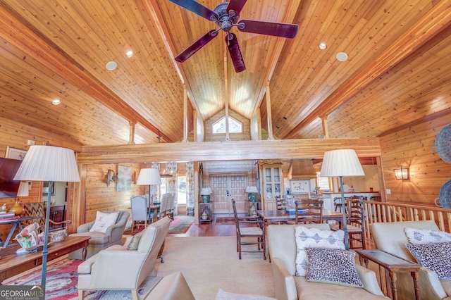 living room featuring ceiling fan, beamed ceiling, wooden walls, and wooden ceiling