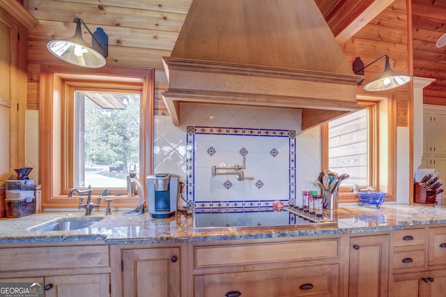 kitchen featuring light brown cabinets, light stone countertops, sink, and wooden ceiling