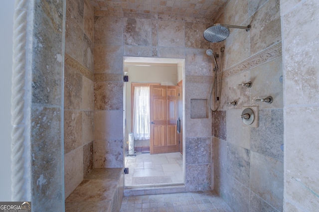 bathroom with tile walls and a tile shower