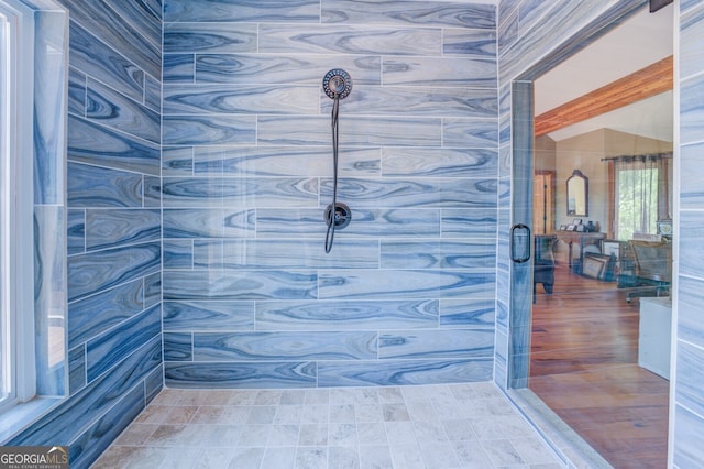 bathroom with a tile shower