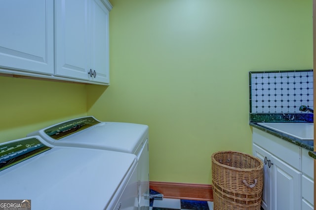 laundry room featuring cabinets, sink, and washing machine and dryer