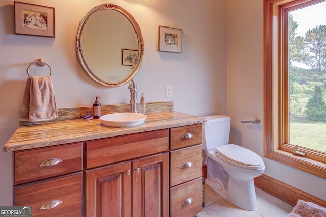 bathroom featuring tile patterned flooring, vanity, and toilet