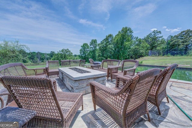 view of patio / terrace with an outdoor living space with a fire pit