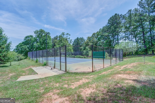 view of sport court featuring a yard