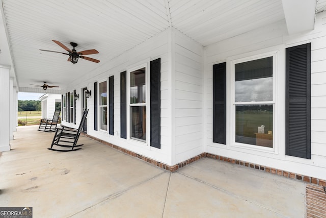 view of patio with ceiling fan and a porch