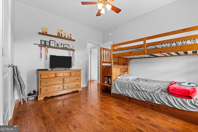 bedroom with ceiling fan and dark hardwood / wood-style flooring