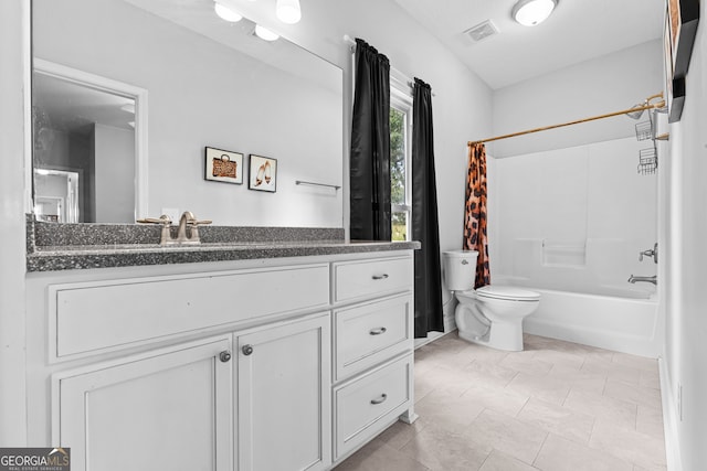 full bathroom featuring toilet, shower / tub combo with curtain, and vanity