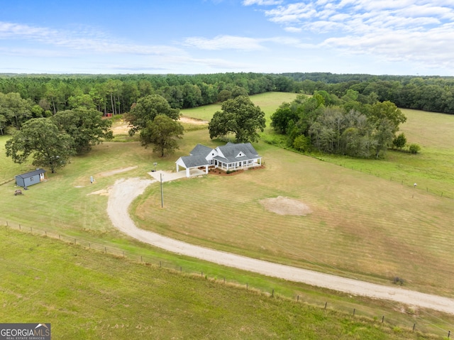 birds eye view of property with a rural view