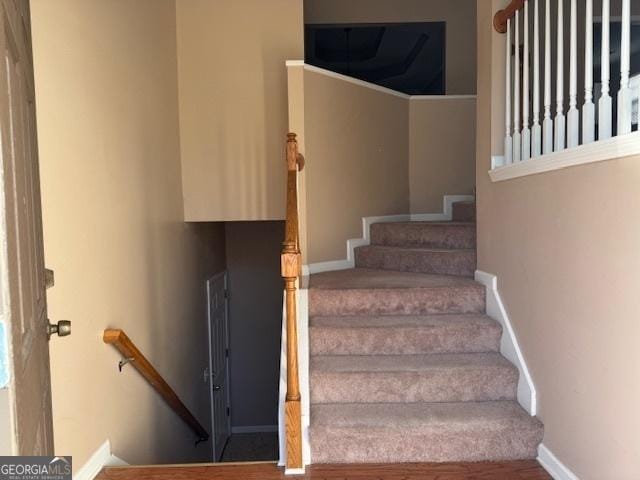 stairway with hardwood / wood-style flooring