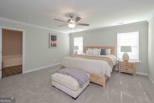 carpeted bedroom with ornamental molding and ceiling fan