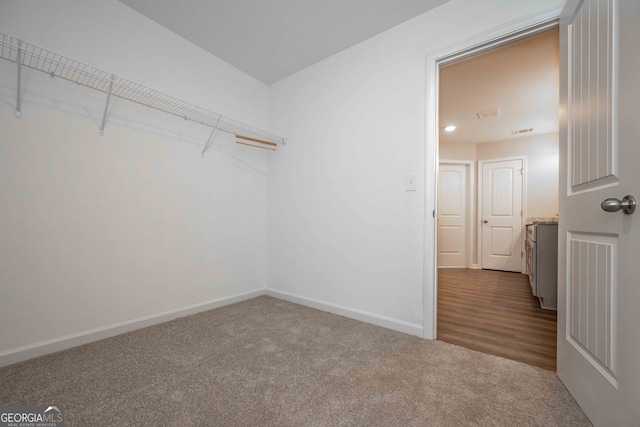 spacious closet with hardwood / wood-style flooring