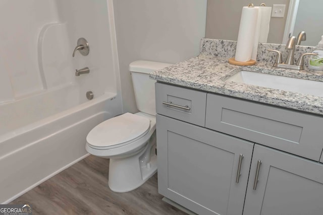 full bathroom featuring shower / bathtub combination, wood-type flooring, vanity, and toilet