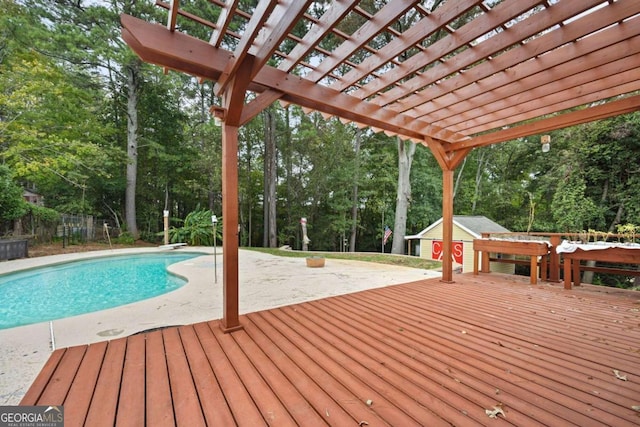 view of pool with a pergola, an outdoor structure, and a deck