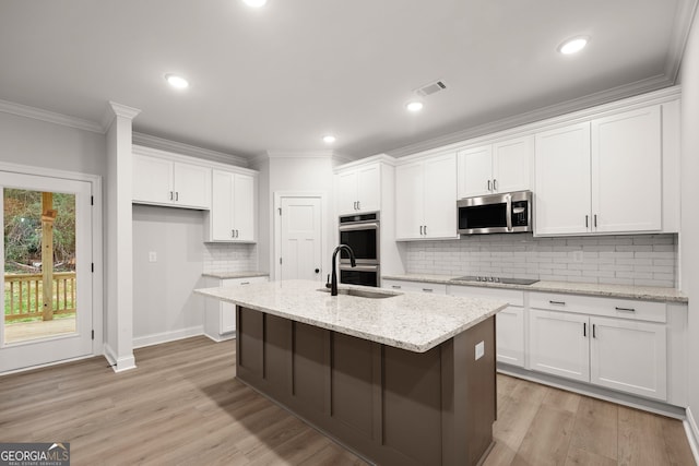 unfurnished living room featuring a wealth of natural light, ornamental molding, light hardwood / wood-style flooring, and ceiling fan