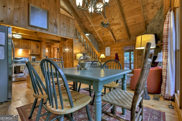 dining area featuring ceiling fan with notable chandelier, wood walls, wooden ceiling, beam ceiling, and light hardwood / wood-style flooring