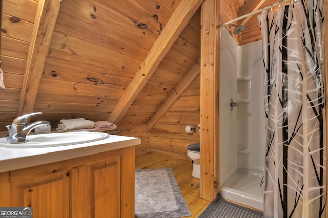 bathroom featuring vaulted ceiling with beams, vanity, hardwood / wood-style flooring, wooden ceiling, and a shower with curtain