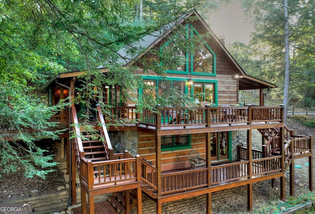 back of house featuring a wooden deck