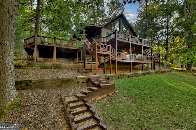 back of house featuring a lawn and a wooden deck