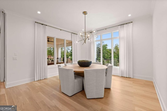 dining space with a chandelier and light hardwood / wood-style floors