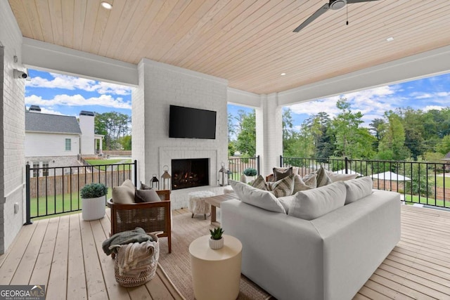 wooden terrace featuring an outdoor living space with a fireplace