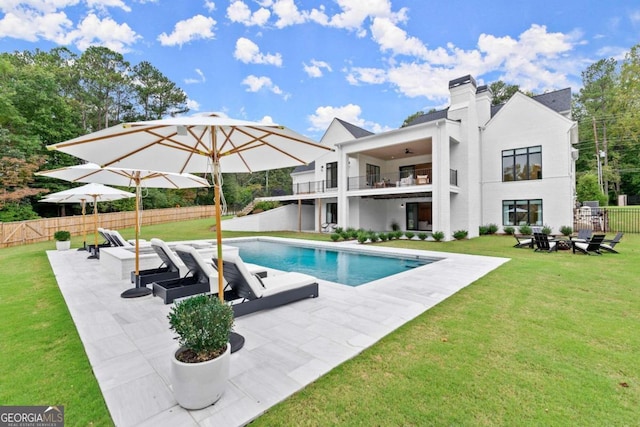 view of pool featuring a lawn and a patio area