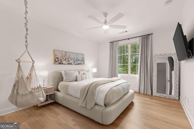 bedroom featuring hardwood / wood-style floors and ceiling fan