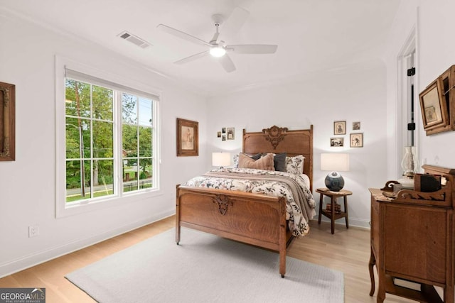 bedroom with light hardwood / wood-style floors and ceiling fan