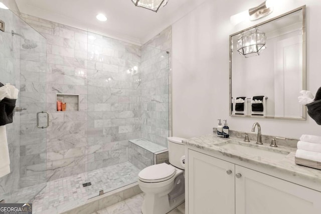 bathroom with a shower with shower door, vanity, and toilet