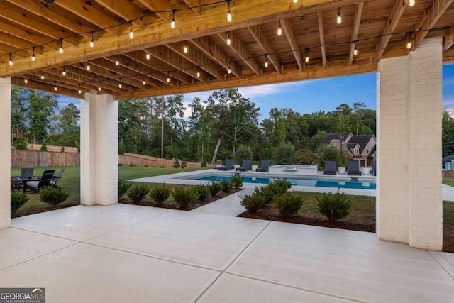 view of patio / terrace with a swimming pool with hot tub