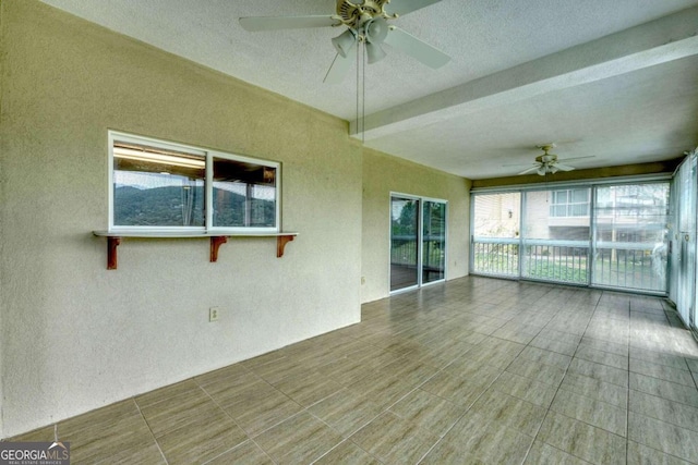 exterior space with ceiling fan and beamed ceiling