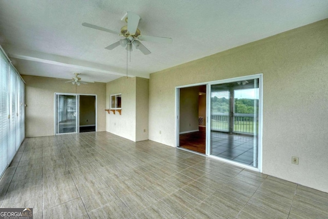 empty room featuring ceiling fan and hardwood / wood-style flooring