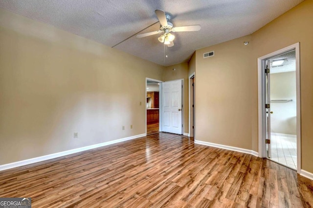 unfurnished bedroom with ceiling fan, a textured ceiling, and light hardwood / wood-style flooring