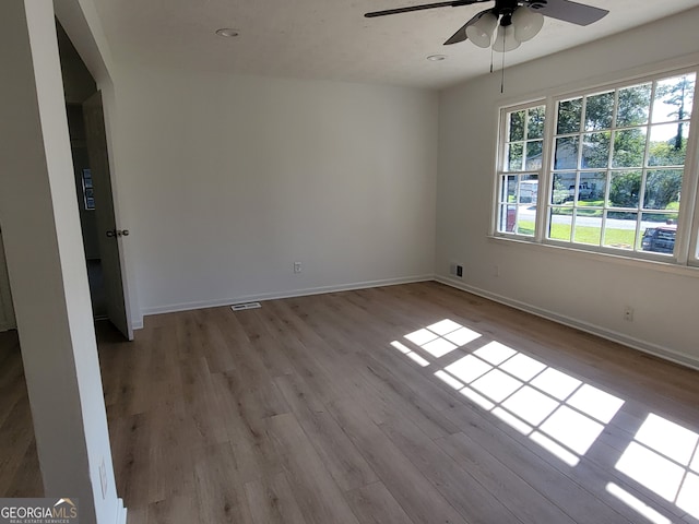 spare room featuring light hardwood / wood-style floors and ceiling fan