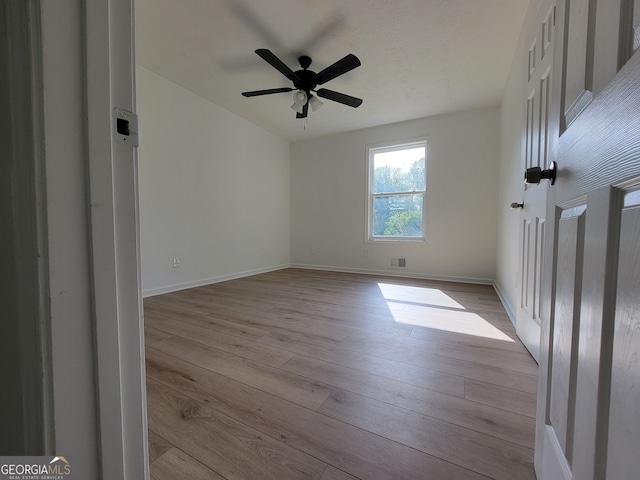 empty room with ceiling fan and light wood-type flooring