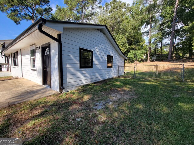 view of property exterior featuring a lawn