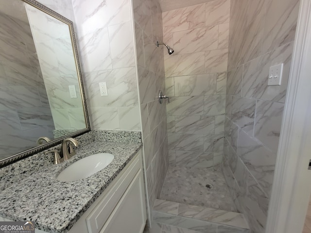 bathroom with vanity and a tile shower