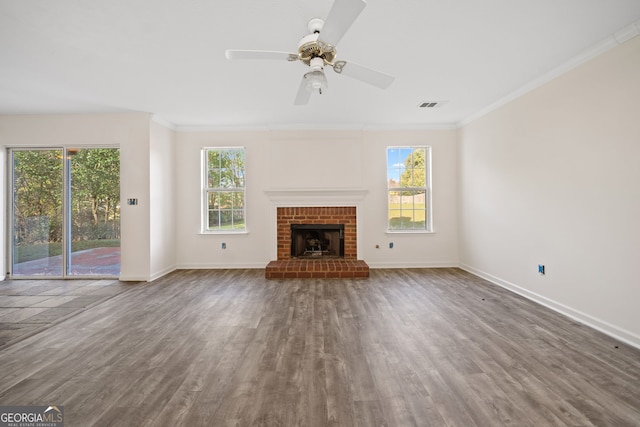 unfurnished living room with ornamental molding, hardwood / wood-style flooring, ceiling fan, and a fireplace