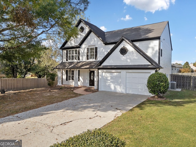 view of front of home featuring a garage, central air condition unit, and a front yard