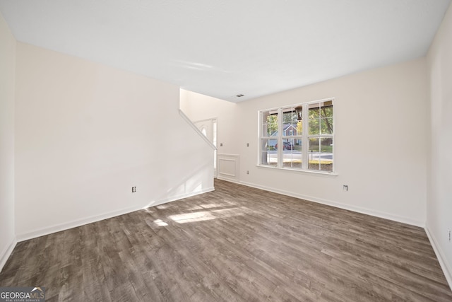 unfurnished living room with dark hardwood / wood-style flooring